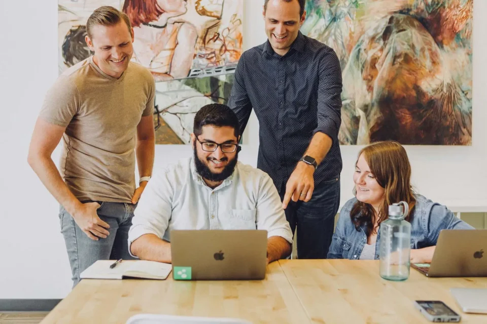A group of people around a laptop