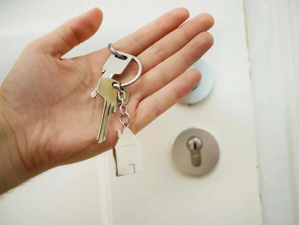 A person holding a house key