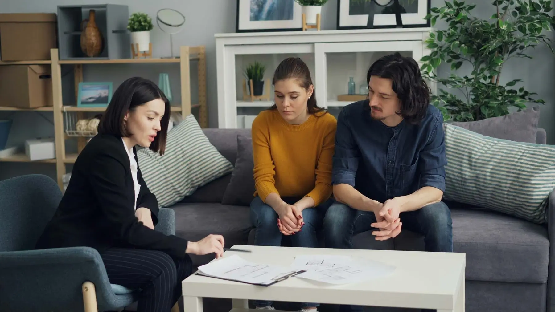A couple speaking to an employee