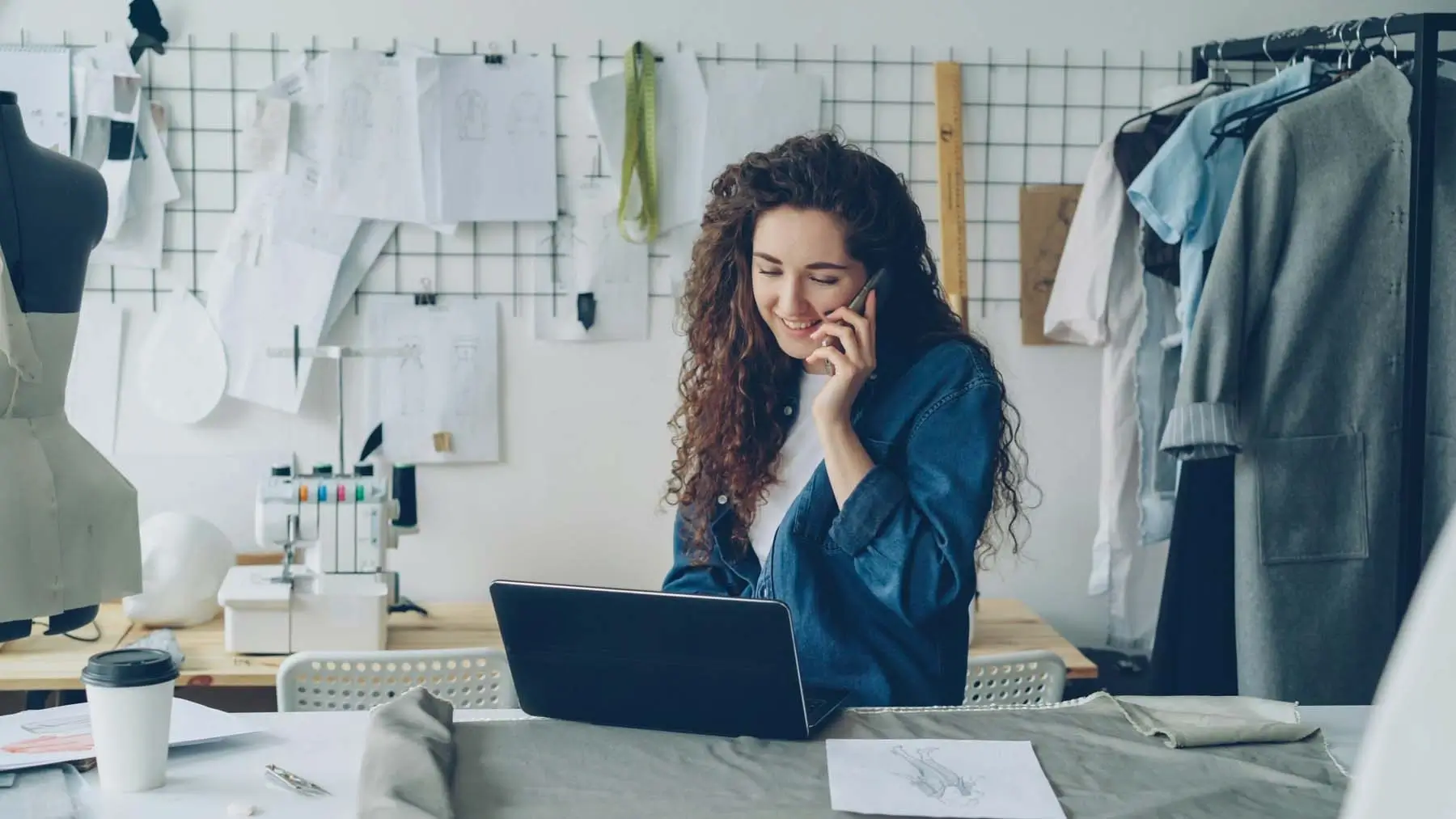 A woman on the phone and using a laptop